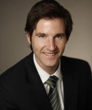 Headshot of David Knight smiling and facing the camera, wearing a suit jacket, dress shirt, and tie.