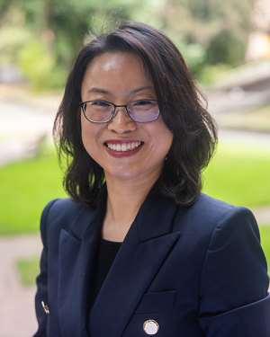 Dr. Min Sun smiles on campus.
