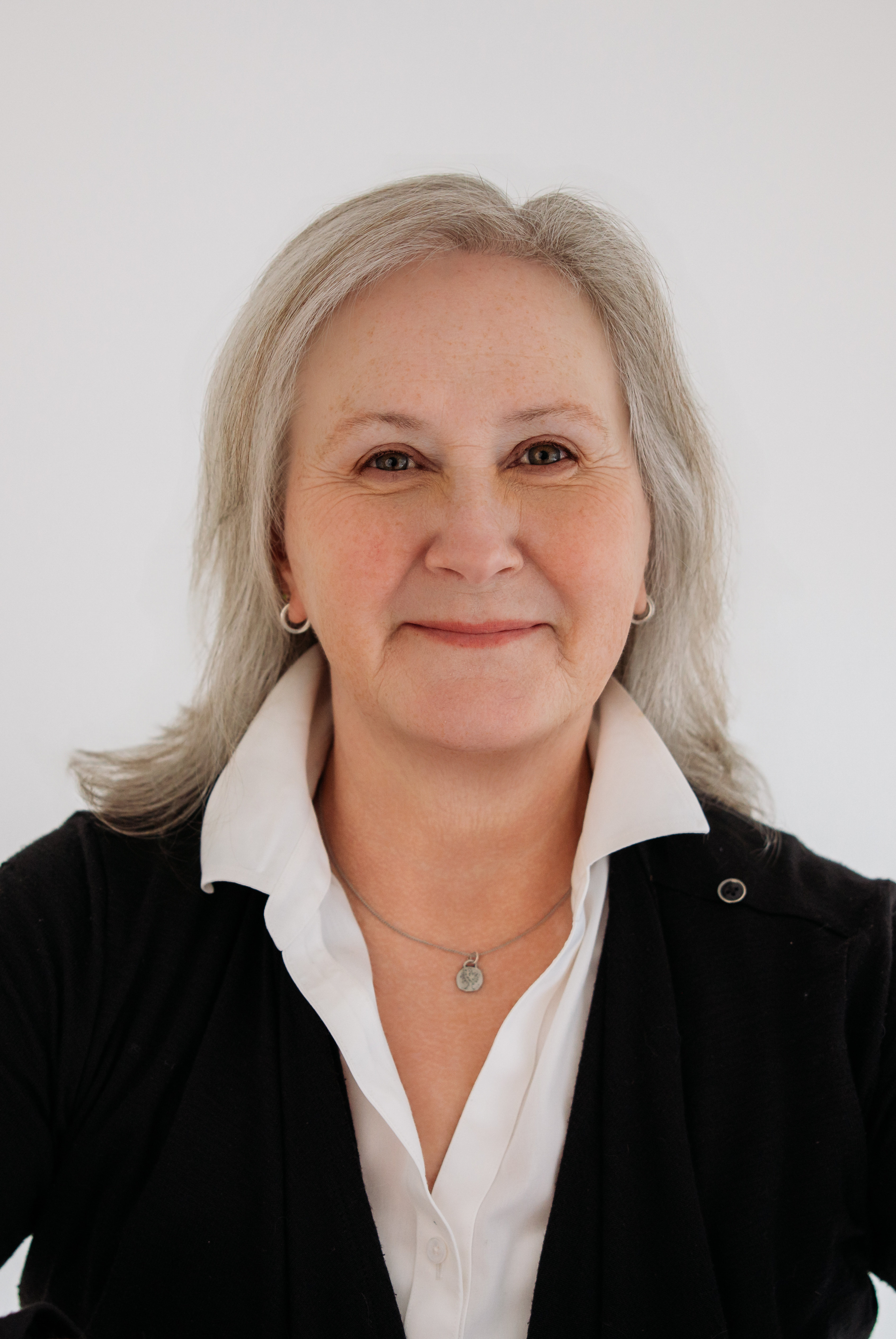 photo of woman wearing white shirt and black cardigan