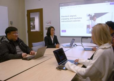 Dr. Min Sun at a conference table showcasing Colleague software